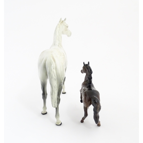 124 - A large Beswick dapple grey hunter horse. Together with a Beswick brown jogging mare. Marked under. ... 