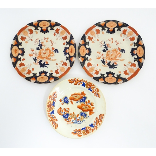 135 - A Derby plate decorated in the Imari palette with flowers and foliage. Together with two similar iro... 