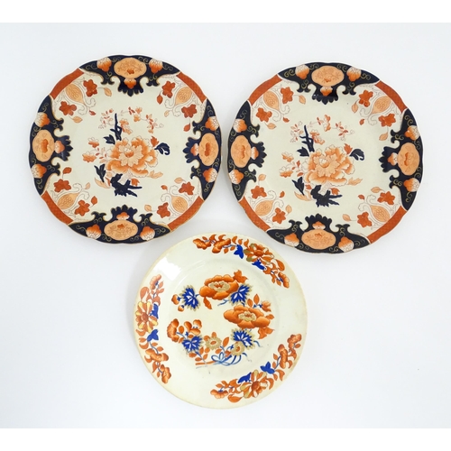 135 - A Derby plate decorated in the Imari palette with flowers and foliage. Together with two similar iro... 