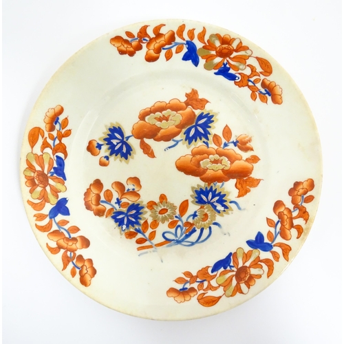 135 - A Derby plate decorated in the Imari palette with flowers and foliage. Together with two similar iro... 