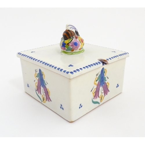 139 - A Poole Pottery honeycomb box and cover with bee finial. Marked under. Approx. 4 1/2