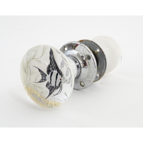 1071 - A pair of 20thC glass door knobs with fish detail. Approx. 2 1/2