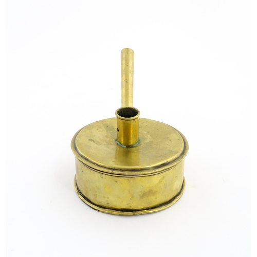 1074 - An 18th / 19thC brass tinder box with chamberstick / candle holder to lid, containing a flint and a ... 