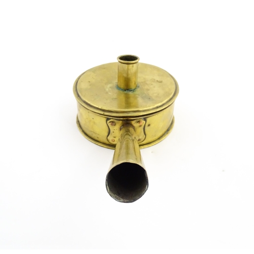 1074 - An 18th / 19thC brass tinder box with chamberstick / candle holder to lid, containing a flint and a ... 