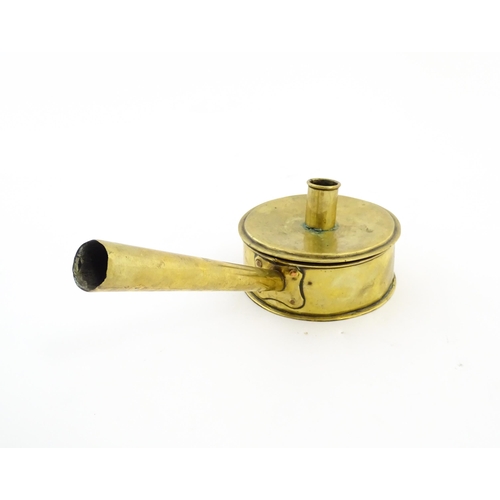 1074 - An 18th / 19thC brass tinder box with chamberstick / candle holder to lid, containing a flint and a ... 