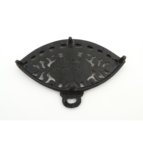 1112 - A late 19th / early 20thC Otto gas iron rest with stylised foliate detail, marked with patent no. 59... 