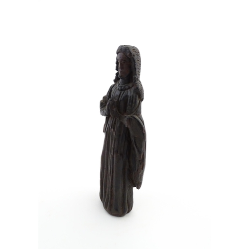 1115 - An 18thC carved wooden figure modelled as a lady in prayer. Approx. 8