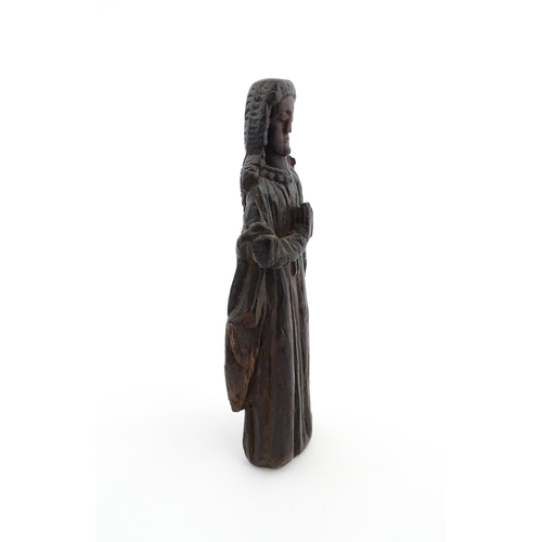 1115 - An 18thC carved wooden figure modelled as a lady in prayer. Approx. 8