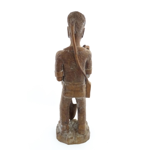 1131 - Ethnographic / Native / Tribal: An African carved wood figure modelled as a male farmer with a spade... 