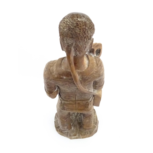 1131 - Ethnographic / Native / Tribal: An African carved wood figure modelled as a male farmer with a spade... 