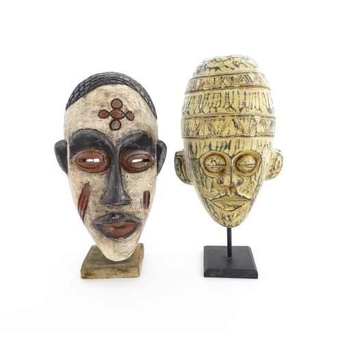 1132 - Ethnographic / Native / Tribal: Two African carved wooden masks with carved decoration, on with poly... 