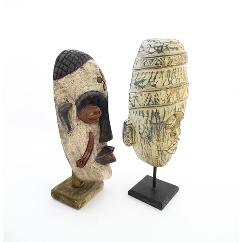 1132 - Ethnographic / Native / Tribal: Two African carved wooden masks with carved decoration, on with poly... 