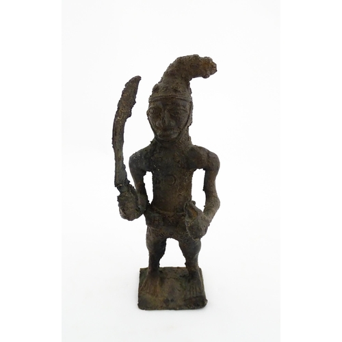 1137 - Ethnographic / Native / Tribal : An African cast bronze model of a warrior holding a weapon. Approx.... 