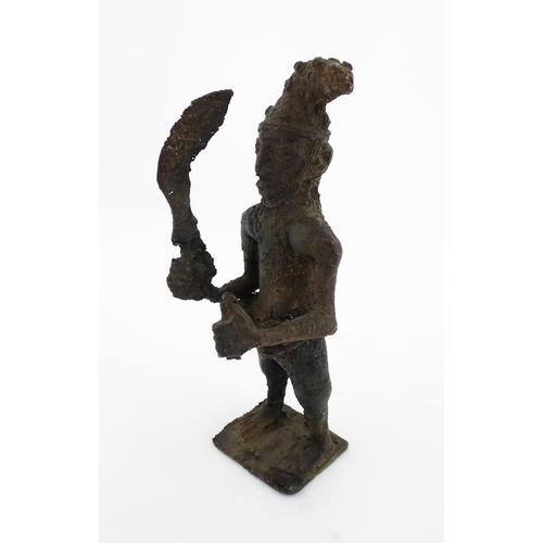 1137 - Ethnographic / Native / Tribal : An African cast bronze model of a warrior holding a weapon. Approx.... 