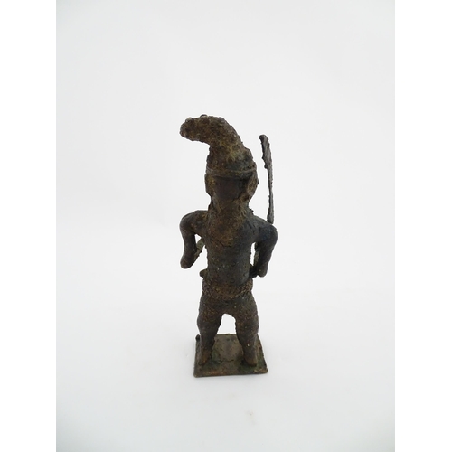 1137 - Ethnographic / Native / Tribal : An African cast bronze model of a warrior holding a weapon. Approx.... 