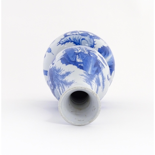 22 - A Chinese blue and white double gourd vase decorated with figures in a landscape. Approx. 16 1/4