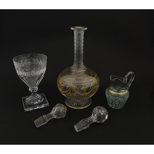 229 - Three items of glassware comprising a Val Saint Lambert glass with squared foot, a decanter with gil... 