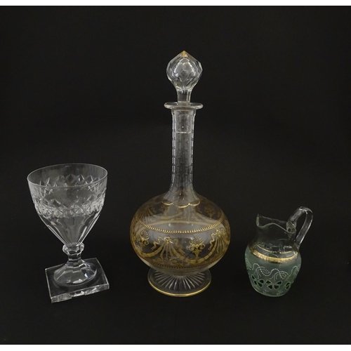 229 - Three items of glassware comprising a Val Saint Lambert glass with squared foot, a decanter with gil... 