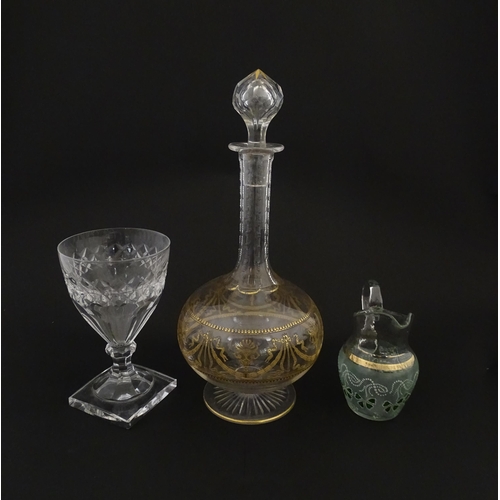 229 - Three items of glassware comprising a Val Saint Lambert glass with squared foot, a decanter with gil... 