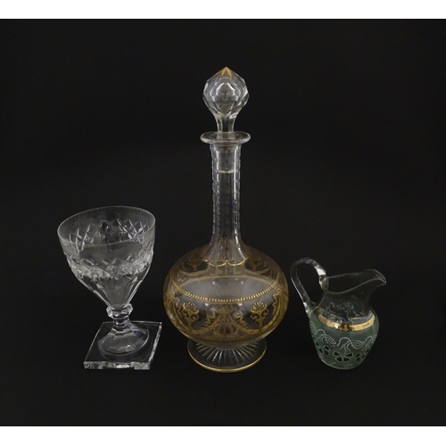 229 - Three items of glassware comprising a Val Saint Lambert glass with squared foot, a decanter with gil... 