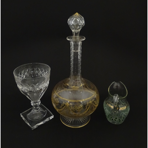 229 - Three items of glassware comprising a Val Saint Lambert glass with squared foot, a decanter with gil... 