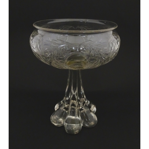 190 - A glass centrepiece bowl comport with engraved floral and foliate detail on a lobed pedestal foot. A... 