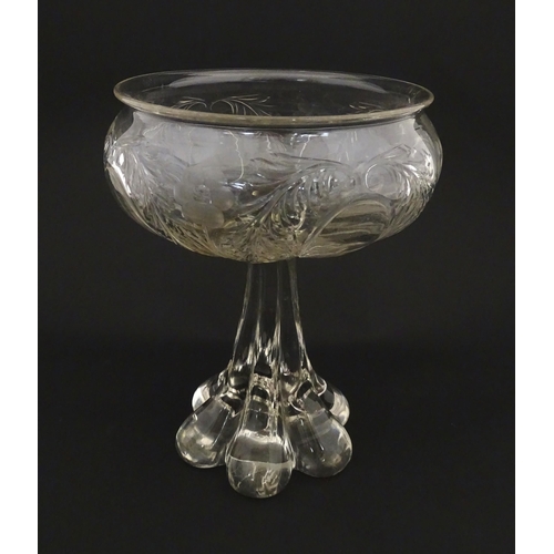 190 - A glass centrepiece bowl comport with engraved floral and foliate detail on a lobed pedestal foot. A... 