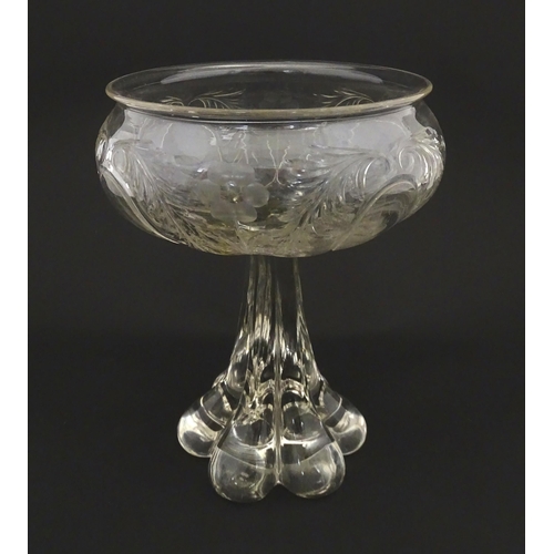 190 - A glass centrepiece bowl comport with engraved floral and foliate detail on a lobed pedestal foot. A... 