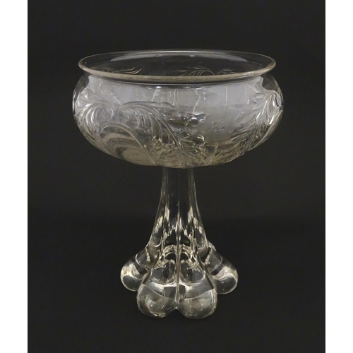 190 - A glass centrepiece bowl comport with engraved floral and foliate detail on a lobed pedestal foot. A... 