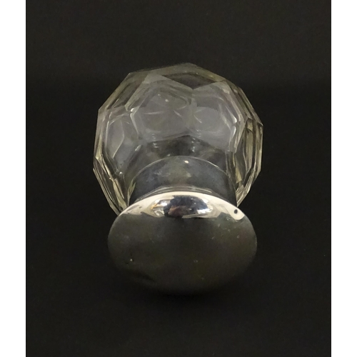 191 - A cut glass scent / perfume bottle with silver top hallmarked Chester 1912. Approx. 2 3/4