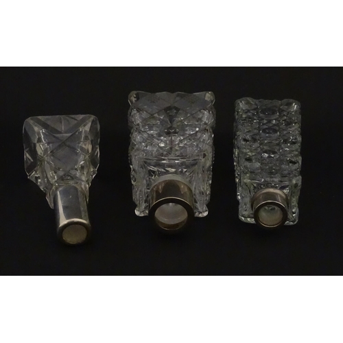 195A - Three assorted cut glass scent / perfume bottles with silver mounts, to include one hallmarked Birmi... 