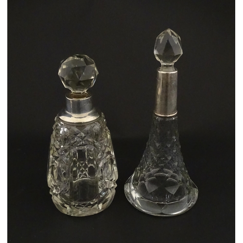 200A - Two cut glass scent / perfume bottles with silver mounts, one hallmarked Birmingham 1921, maker A J ... 