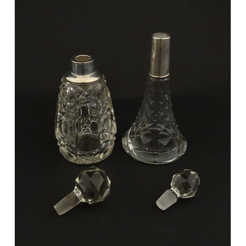 200A - Two cut glass scent / perfume bottles with silver mounts, one hallmarked Birmingham 1921, maker A J ... 