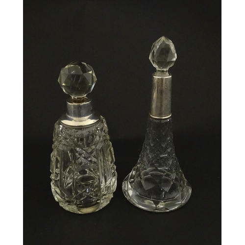 200A - Two cut glass scent / perfume bottles with silver mounts, one hallmarked Birmingham 1921, maker A J ... 