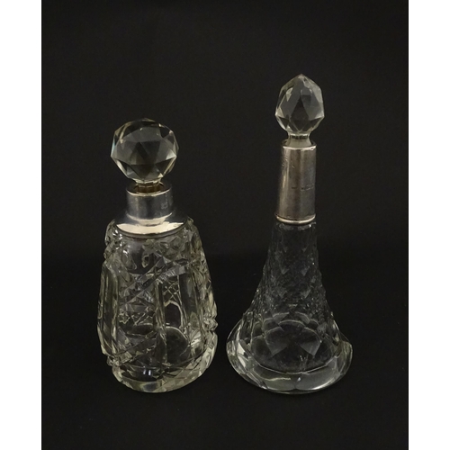 200A - Two cut glass scent / perfume bottles with silver mounts, one hallmarked Birmingham 1921, maker A J ... 