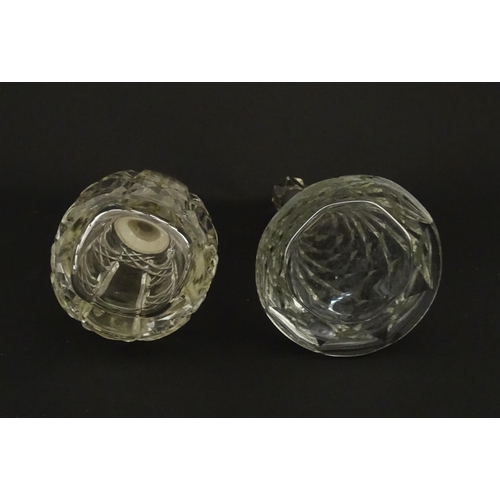 200A - Two cut glass scent / perfume bottles with silver mounts, one hallmarked Birmingham 1921, maker A J ... 