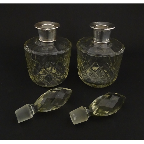 205 - Two glass flasks formed as small cut glass decanters with Argentinian .925 silver mounts. Approx. 8