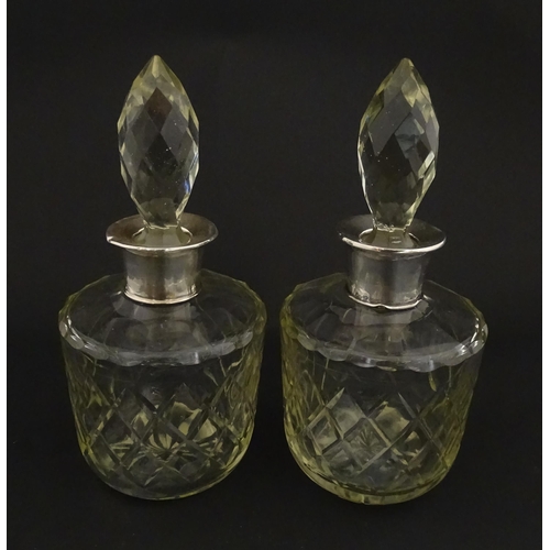 205 - Two glass flasks formed as small cut glass decanters with Argentinian .925 silver mounts. Approx. 8