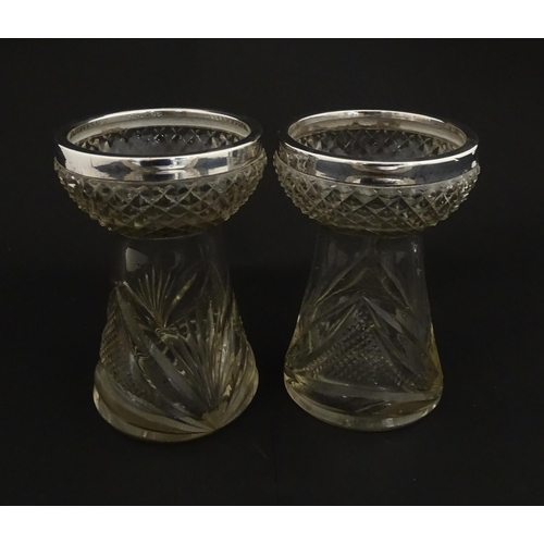 217 - A pair of cut glass vases with silver rims in the style of hyacinth vases, hallmarked Birmingham 190... 