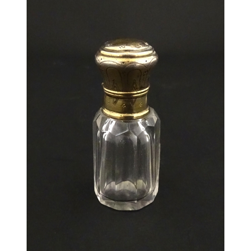 221 - A French scent / perfume bottle with silver gilt top. Approx. 2 1/4