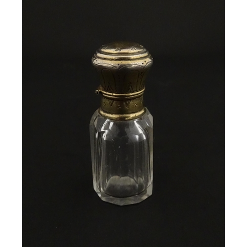 221 - A French scent / perfume bottle with silver gilt top. Approx. 2 1/4