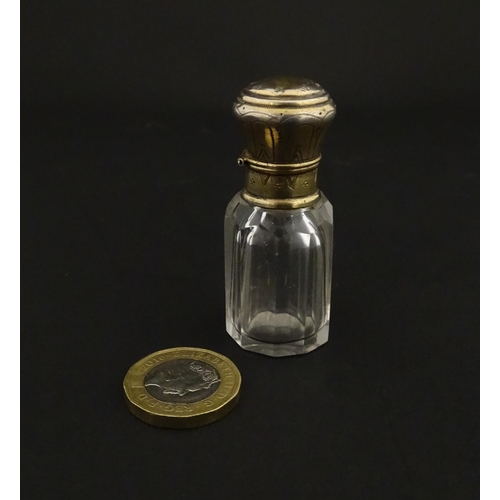 221 - A French scent / perfume bottle with silver gilt top. Approx. 2 1/4