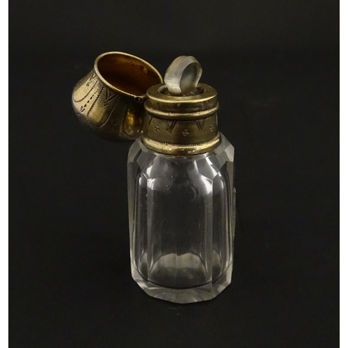 221 - A French scent / perfume bottle with silver gilt top. Approx. 2 1/4