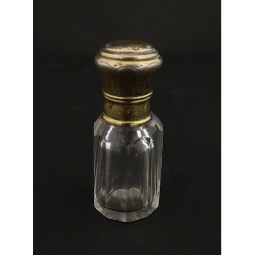 221 - A French scent / perfume bottle with silver gilt top. Approx. 2 1/4