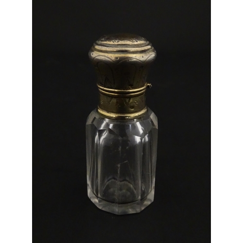 221 - A French scent / perfume bottle with silver gilt top. Approx. 2 1/4