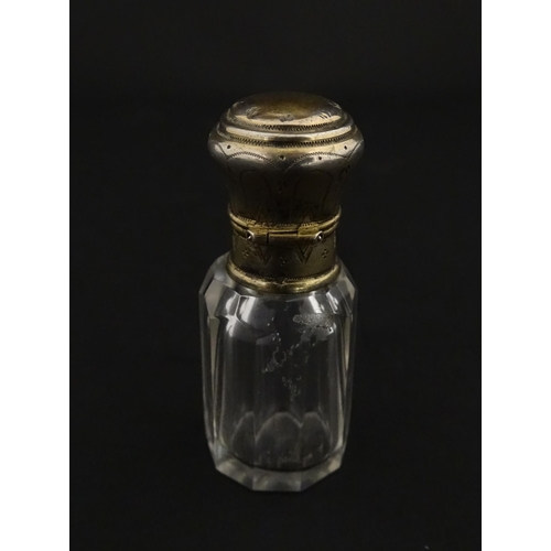 221 - A French scent / perfume bottle with silver gilt top. Approx. 2 1/4