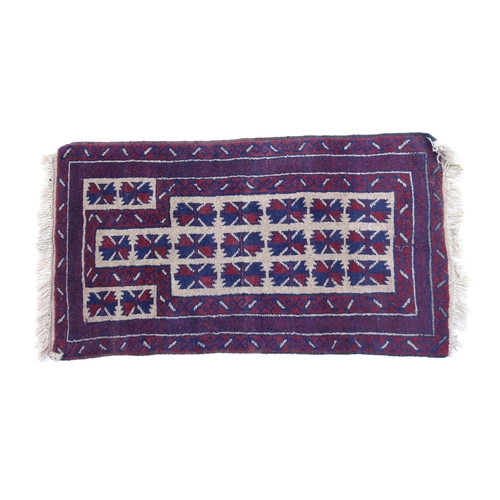 1369 - Carpet / Rug : A red, blue and cream ground rug with repeating geometric motifs. Approx. 55