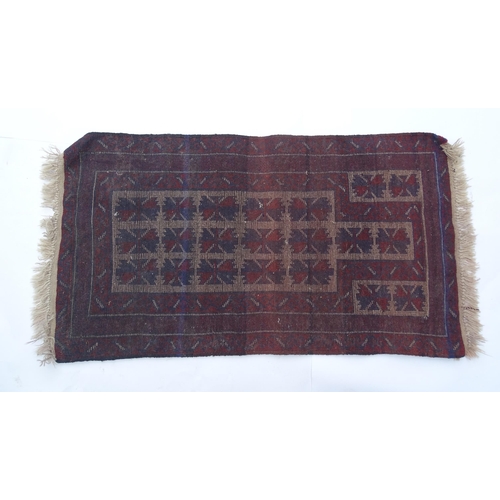 1369 - Carpet / Rug : A red, blue and cream ground rug with repeating geometric motifs. Approx. 55