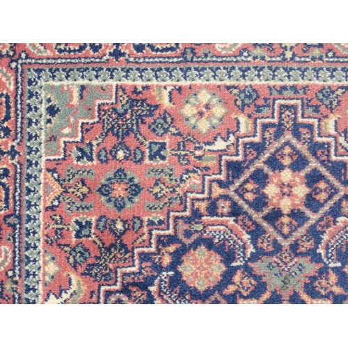 1372 - Carpet / Rug : A blue ground runner decorated with three central medallions with floral and scroll d... 