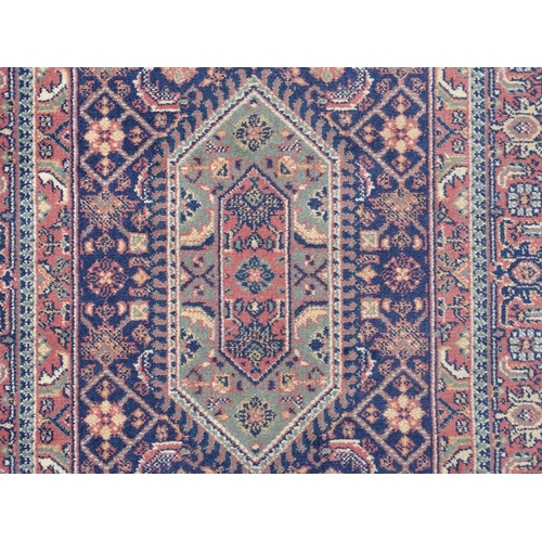 1372 - Carpet / Rug : A blue ground runner decorated with three central medallions with floral and scroll d... 